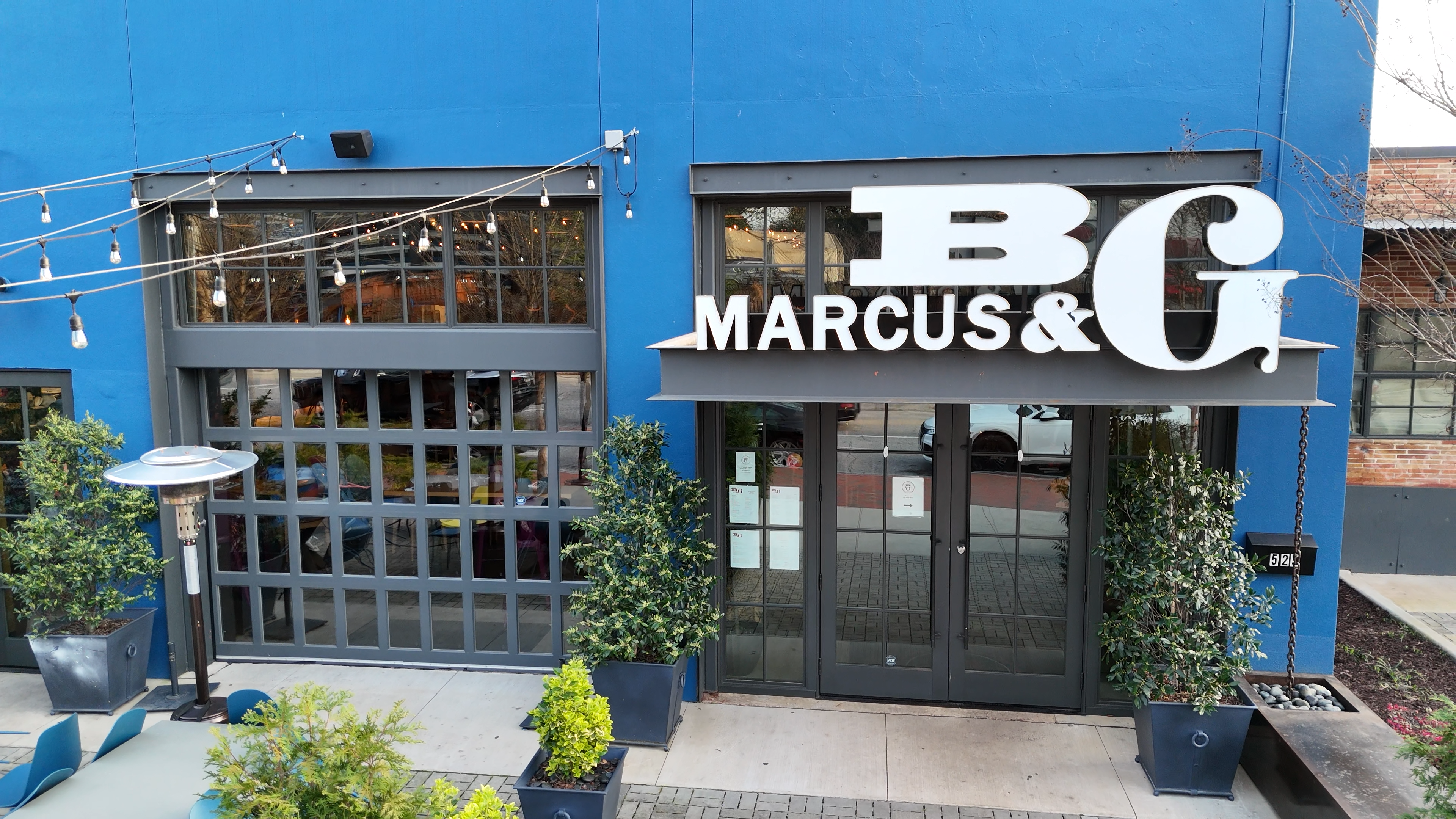 The welcoming front entrance of Marcus Bar & Grille in Atlanta, with its distinctive signage and modern facade.