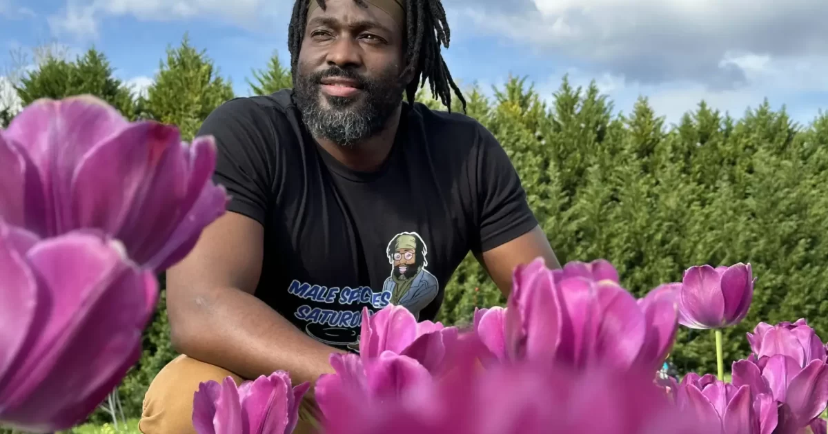 KB sitting among tulips at Yule Forest, enjoying the scenery.