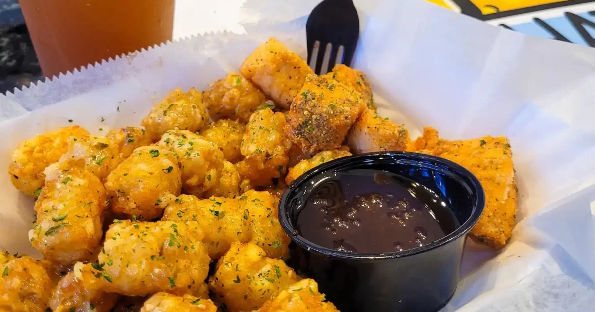 Tater tots tossed in honey garlic with salmon bites and Arnold Palmer at Chattahoochee Food Works.