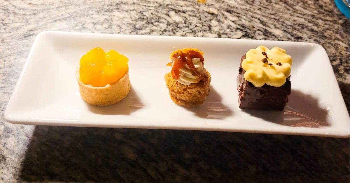 A plate of three beautifully crafted petit fours served at Lazy Betty, showcasing their attention to detail in desserts.