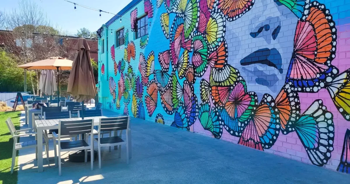 Outdoor seating area with colorful mural at Chattahoochee Food Works.