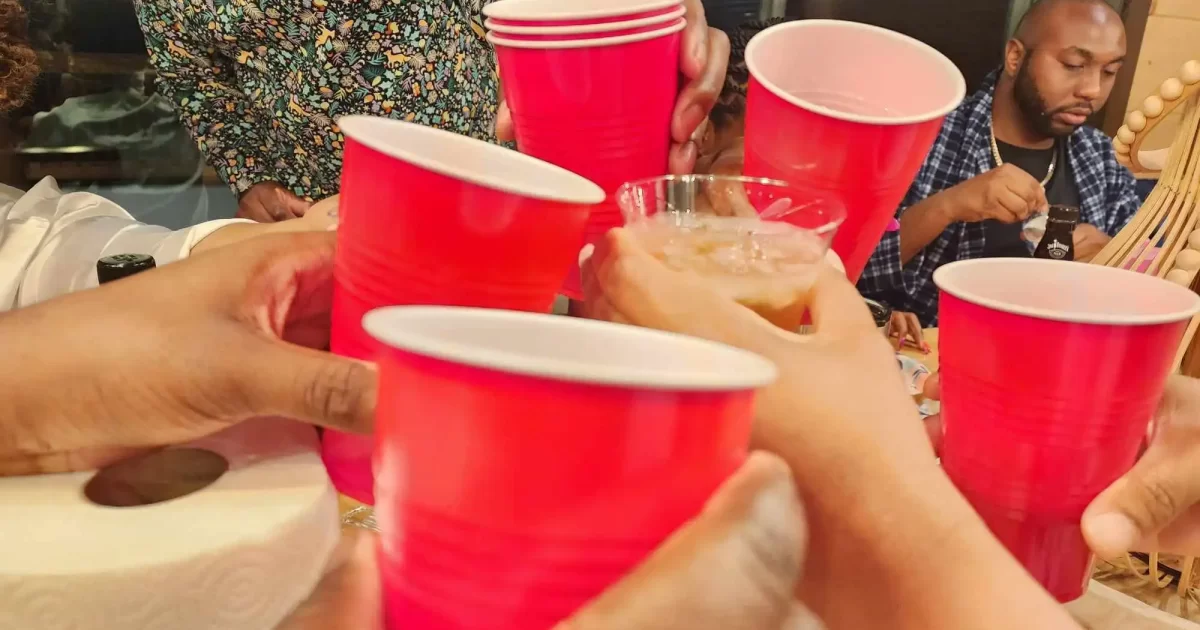 Friends raising red cups for a toast during the cabin trip in Gatlinburg, Tennessee.