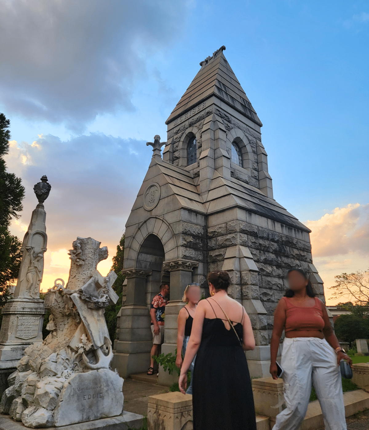 Visitors exploring a mausoleum during the Love Stories of Oakland Cemetery tour at sunset.