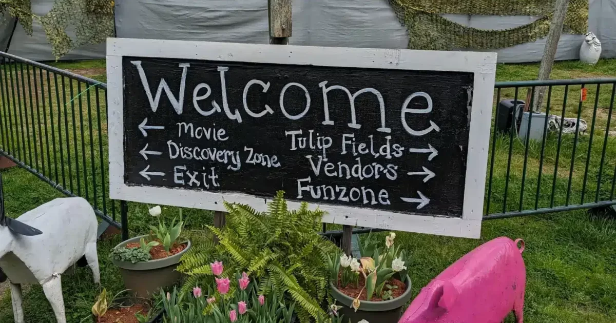 Welcome sign at the entrance of Tulip Festival at Yule Forest with directions to various attractions.